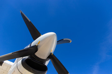 bottom view of aircraft propeller blade and turboprop engines with blue sky background
