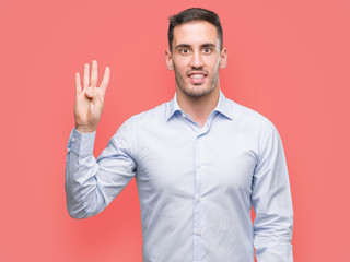 Handsome young businessman showing and pointing up with fingers number four while smiling confident and happy.