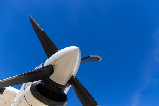 bottom view of aircraft propeller blade and turboprop engines with blue sky background