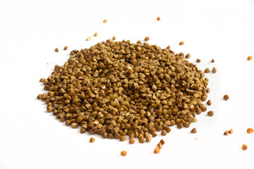 Buckwheat groats scattered on a white background