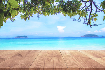 Wood table with blue sea and sand beach background