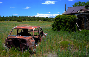 Fototapeta premium Rusted Wreck and Abandoned Building
