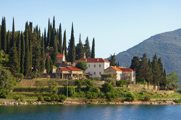 Fototapeta na wymiar Religious architecture. Ancient Orthodox Monastery. Montenegro, Risan, view of Banja Monastery on coast of Kotor Bay
