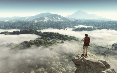 Hiker on the top of the mountain looking at the landscape