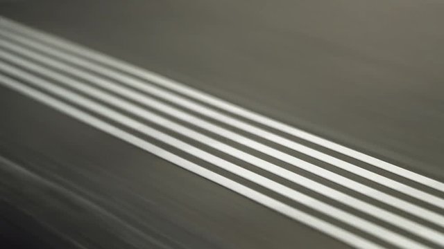 White lines passing by seen through trian window