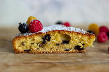 a piece of cake with berries lies on a close-up table