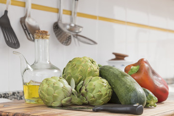 still life with raw vegetables and oil in the kitchen