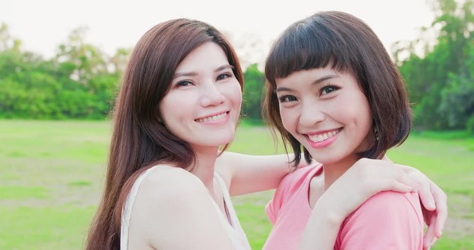 two women smile happily
