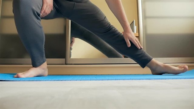 Man does gymnastics at home. Slow motion
