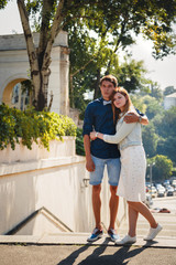 Happy stylish loving couple of hipsters hugging in a park