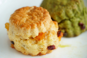 Two scone on white plate.