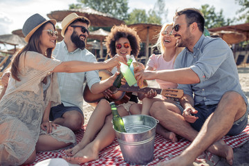 Friends having fun at the beach on a sunny day