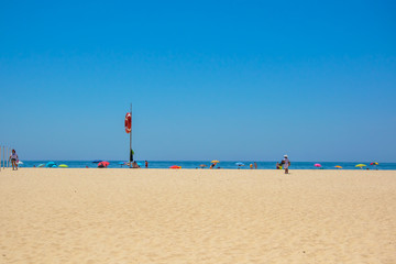 People enjoing at Tavira beach in Portugal