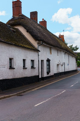 Old houses under thatched roof in the city of Crediton, Devon, United Kingdom June 2, 2018