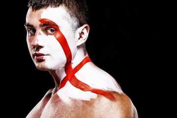 Soccer or football fan with bodyart on face with agression - flag of England.