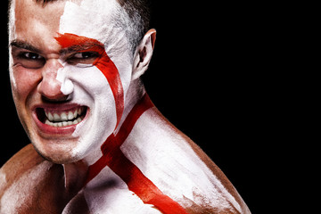 Soccer or football fan with bodyart on face with agression - flag of England.