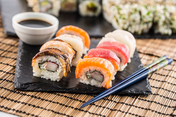 Set of roll sushi gold california with chopsticks and soy sauce.