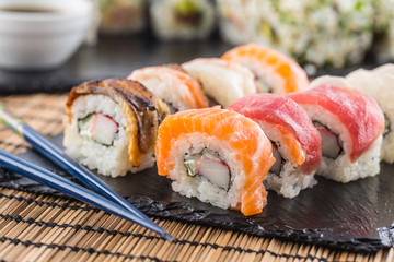 Set of roll sushi gold california with chopsticks and soy sauce.