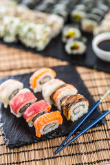 Set of roll sushi gold california with chopsticks and soy sauce.