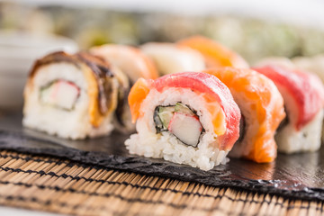 Set of roll sushi gold california with chopsticks and soy sauce.