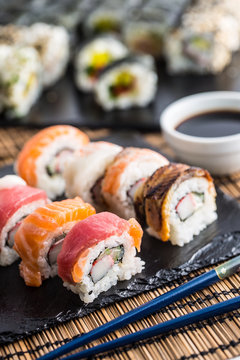 Set of roll sushi gold california with chopsticks and soy sauce.