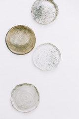 Hand made plates on white background. Flat lay, top view minimal pottery concept.
