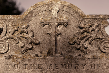 Genealogy and ancestry. Old graveyard headstone 'to the memory of'.