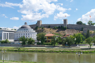 Fototapeta na wymiar The walls of Kale Fortress over government buildings on the banks of the Vardar River in Skopje
