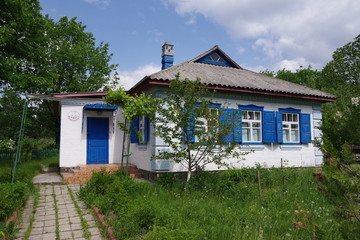 old house with white walls and blue shutters