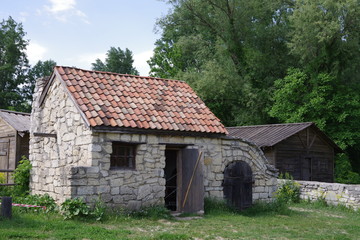 Fototapeta na wymiar small stone building near trees