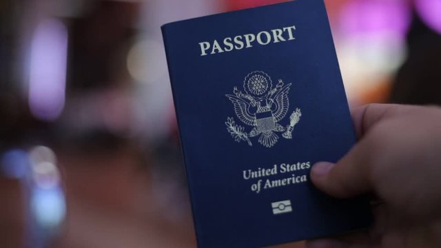 Holding a blue American passport