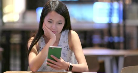 Woman read on mobile phone in coffee shop