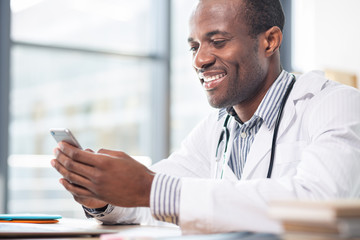 Joyful male person reading news