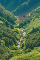 Fototapeta premium The Grand Canyon of the Bzerpi River. High mountain peaks and blue sky. Mountain tourism.