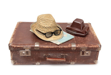 Vintage suitcase and old camera on a white background
