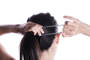 Asian woman tying her hair