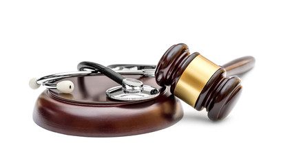 Gavel with stethoscope on stand. Isolated on white. Medical law concept.