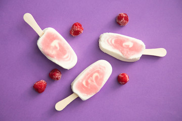 Popsicle with fresh raspberry on a table