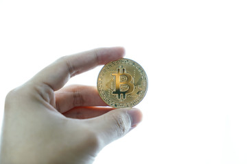 hand with golden bitcoin coin on the white background.