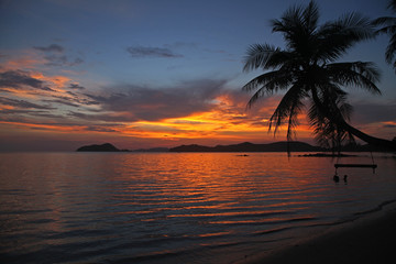 Fototapeta na wymiar swing or cradle hang on the coconut tree beautiful sunset at koh Mak beach Trad Thailand