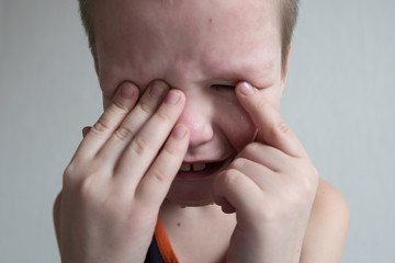 Boy cries with tears. Upset child. Violence in family over children. Concept of bullying,...