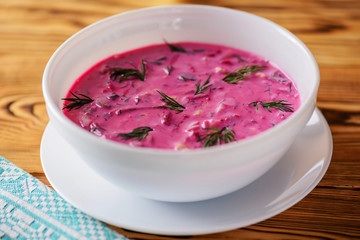 Cold beetroot (beet) soup on yogurt with egg, onion and cucumbers