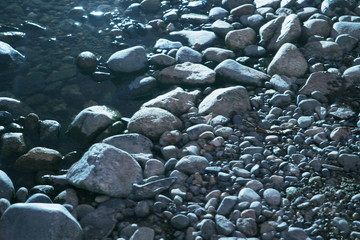 Smooth water worn rocks or stones in a riverbed