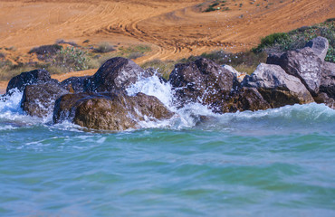 waves beach wind stones