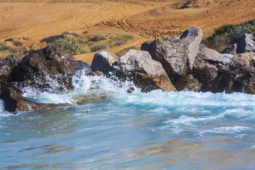 waves beach wind stones