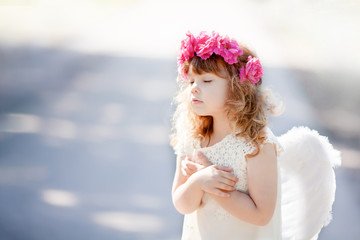 Portrait of beautiful little Angel girl with floral wreath