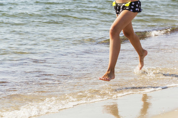 On the sea-running on the beach on a Sunny day.