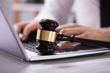 Wooden Mallet On Laptop Keypad