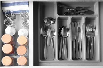 Set of cutlery in kitchen drawer