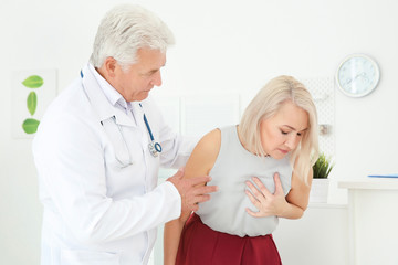Senior woman having heart attack in clinic